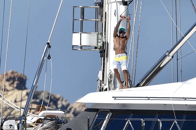 Formula 1 driver Lewis Hamilton pictured aboard a luxury yacht in Sardinia, Italy last month 